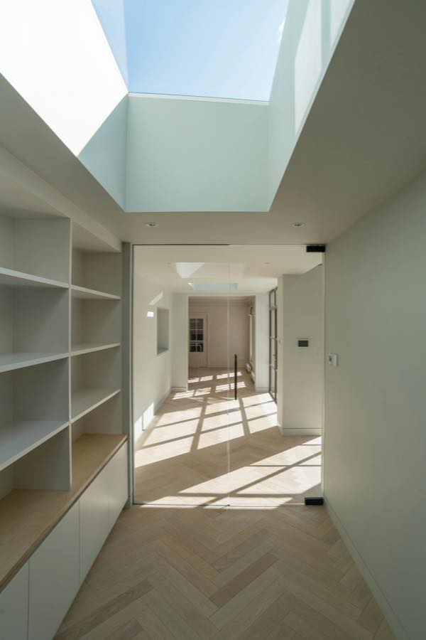 Interior terminado con iluminación empotrada, carpintería a medida y pavimento de madera